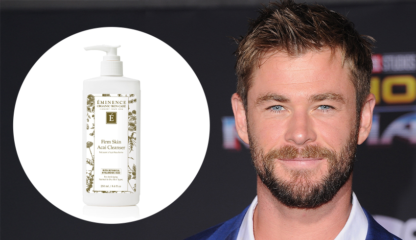 An autographed photo of Celebrity Chris Hemsworth displayed next to a  movie poster
